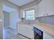 Kitchen view featuring wood countertops, ample cabinets, stainless steel sink under window, with wood-look tile floor at 4228 Sunny Land Dr, Lakeland, FL 33813