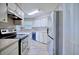 Well-lit kitchen featuring stainless steel refrigerator and modern appliances, plus wood-look tile flooring at 4228 Sunny Land Dr, Lakeland, FL 33813