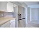 Kitchen featuring stainless refrigerator with wood countertop, white cabinets and wood-look tile floor at 4228 Sunny Land Dr, Lakeland, FL 33813