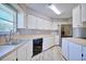 Bright kitchen with stainless steel appliances, wood countertops, white cabinets, and wood-look tile flooring at 4228 Sunny Land Dr, Lakeland, FL 33813