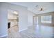 View of open floor plan with kitchen on left, living room in center and entry to right featuring modern neutral tones at 4228 Sunny Land Dr, Lakeland, FL 33813