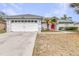 Classic single-story home featuring an attached two-car garage and neatly landscaped front yard at 423 Lark Ct, Kissimmee, FL 34759