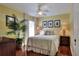 Cozy bedroom featuring a ceiling fan, natural light, wood floors, and tasteful decor at 4488 Whistlewood Cir, Lakeland, FL 33811