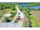 Aerial view of the guarded community entrance, with beautiful landscaping and a glimpse of the lake at 4488 Whistlewood Cir, Lakeland, FL 33811