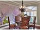 Dining area showcasing a decorative chandelier, elegant furniture, and an arched window at 4488 Whistlewood Cir, Lakeland, FL 33811