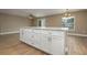 Kitchen island featuring white cabinets and a light countertop, open to the living area at 45 Powell Rd, Winter Haven, FL 33880