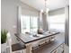 Well-lit dining area featuring a stylish table set, bench, and views through a sliding glass door at 472 Ituna Cir, Winter Haven, FL 33881