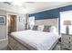 Comfortable bedroom boasts a king bed, stylish decor, and ensuite bathroom access at 472 Ituna Cir, Winter Haven, FL 33881