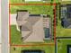 Aerial image of the home showcasing the roof, screened pool, and landscaping at 5020 Truman Ln, Lakeland, FL 33812