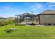 A backyard featuring a screened-in pool and well-maintained lawn at 5020 Truman Ln, Lakeland, FL 33812