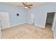 Bedroom with a ceiling fan, carpeted floors, and doors leading to closet and bathroom at 5020 Truman Ln, Lakeland, FL 33812