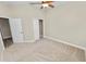Neutral bedroom with carpet, ceiling fan, and closet offers a serene, comfortable space at 5020 Truman Ln, Lakeland, FL 33812