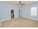 Bedroom featuring a ceiling fan, neutral carpet, and an ensuite bath at 5020 Truman Ln, Lakeland, FL 33812