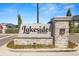 Close-up of the stone 'Lakeside Heritage' community sign with manicured flower beds and a security system at 5020 Truman Ln, Lakeland, FL 33812