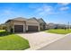 Beautiful home showcasing three car garage, with manicured lawn and paved driveway at 5020 Truman Ln, Lakeland, FL 33812