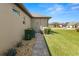 Exterior shot showcasing the home's side with walkway, landscaping, and neutral color palette at 5020 Truman Ln, Lakeland, FL 33812