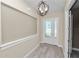 Bright, neutral-toned foyer with a modern light fixture and light wood floors at 5020 Truman Ln, Lakeland, FL 33812