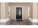 Close-up of the front door on a lovely porch with stylish stonework and a 'Welcome' mat at 5020 Truman Ln, Lakeland, FL 33812