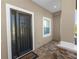 Elegant front entrance with a decorative glass door and a 'Welcome' mat on a brick patio at 5020 Truman Ln, Lakeland, FL 33812