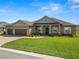 Charming single-story home with a well-manicured lawn, paver driveway and a welcoming entrance at 5020 Truman Ln, Lakeland, FL 33812