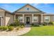 Inviting front porch with a patterned walkway, decorative columns, and a stylish glass door at 5020 Truman Ln, Lakeland, FL 33812