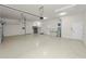 A spacious three-car garage featuring painted floor, cabinetry and service door to the exterior at 5020 Truman Ln, Lakeland, FL 33812