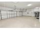 Spacious three-car garage with epoxy flooring, overhead storage, and ample lighting at 5020 Truman Ln, Lakeland, FL 33812