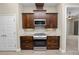Modern kitchen features dark wood cabinets and stainless steel appliances at 5020 Truman Ln, Lakeland, FL 33812