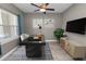 Modern office with a ceiling fan, a large window, and a work desk with a geometric rug at 5020 Truman Ln, Lakeland, FL 33812