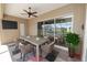 Inviting patio with a ceiling fan and dining table, overlooking a screened-in pool area at 5020 Truman Ln, Lakeland, FL 33812