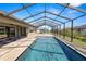 Sparkling pool in a screened enclosure with a paver deck, perfect for relaxation and leisure at 5020 Truman Ln, Lakeland, FL 33812
