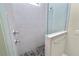 Modern shower featuring sleek gray tiles, pebble floor, and glass enclosure at 5020 Truman Ln, Lakeland, FL 33812