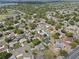 Expansive aerial view of the property showcasing its neighborhood, landscaping, and proximity to amenities at 5432 Weber Pl, Lakeland, FL 33809