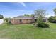Brick house, nicely manicured lawn and mature trees in the backyard at 5432 Weber Pl, Lakeland, FL 33809