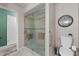 Bathroom featuring glass enclosed shower with bench seat and sleek fixtures at 5432 Weber Pl, Lakeland, FL 33809