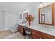 Bright bathroom featuring double sinks, wooden cabinets and luxurious marble countertops at 5432 Weber Pl, Lakeland, FL 33809