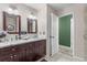Bathroom featuring double sinks with dark wood cabinets and tile floors at 5432 Weber Pl, Lakeland, FL 33809