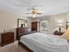 Bedroom featuring dark wood furniture, ceiling fan, and natural light at 5432 Weber Pl, Lakeland, FL 33809