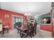 Formal dining room with elegant chandelier, dark wood table, and access to the living area at 5432 Weber Pl, Lakeland, FL 33809