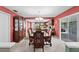 Formal dining room with elegant chandelier, dark wood table and chairs, and access to outdoor patio at 5432 Weber Pl, Lakeland, FL 33809