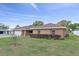 Charming brick home featuring an attached garage, well-maintained lawn, and neat landscaping at 5432 Weber Pl, Lakeland, FL 33809