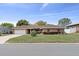 Charming single-story brick home featuring an attached two-car garage and well-manicured front lawn at 5432 Weber Pl, Lakeland, FL 33809
