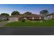Charming single-story brick home at twilight featuring an attached two-car garage and manicured front lawn at 5432 Weber Pl, Lakeland, FL 33809