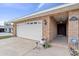 Attached two-car garage with white door and brick facade, leading to the front entryway at 5432 Weber Pl, Lakeland, FL 33809