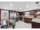 Modern kitchen featuring granite countertops, stainless steel appliances, and dark wood cabinetry at 5432 Weber Pl, Lakeland, FL 33809