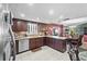 Well-equipped kitchen with granite countertops, stainless steel appliances, and dark wood cabinetry at 5432 Weber Pl, Lakeland, FL 33809