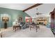 Bright living room features a stone fireplace, beamed ceiling, plush seating, and ample natural light at 5432 Weber Pl, Lakeland, FL 33809