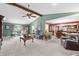 Spacious living room showcases a beamed ceiling, carpeted floor, and seamless transition to dining and kitchen areas at 5432 Weber Pl, Lakeland, FL 33809