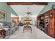 Open-concept living room boasts a stone fireplace, beamed ceiling, and seamless flow to the kitchen and dining areas at 5432 Weber Pl, Lakeland, FL 33809