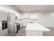 Open kitchen with stainless steel appliances, a kitchen island, and white cabinetry at 5752 Anders Way, St Cloud, FL 34771